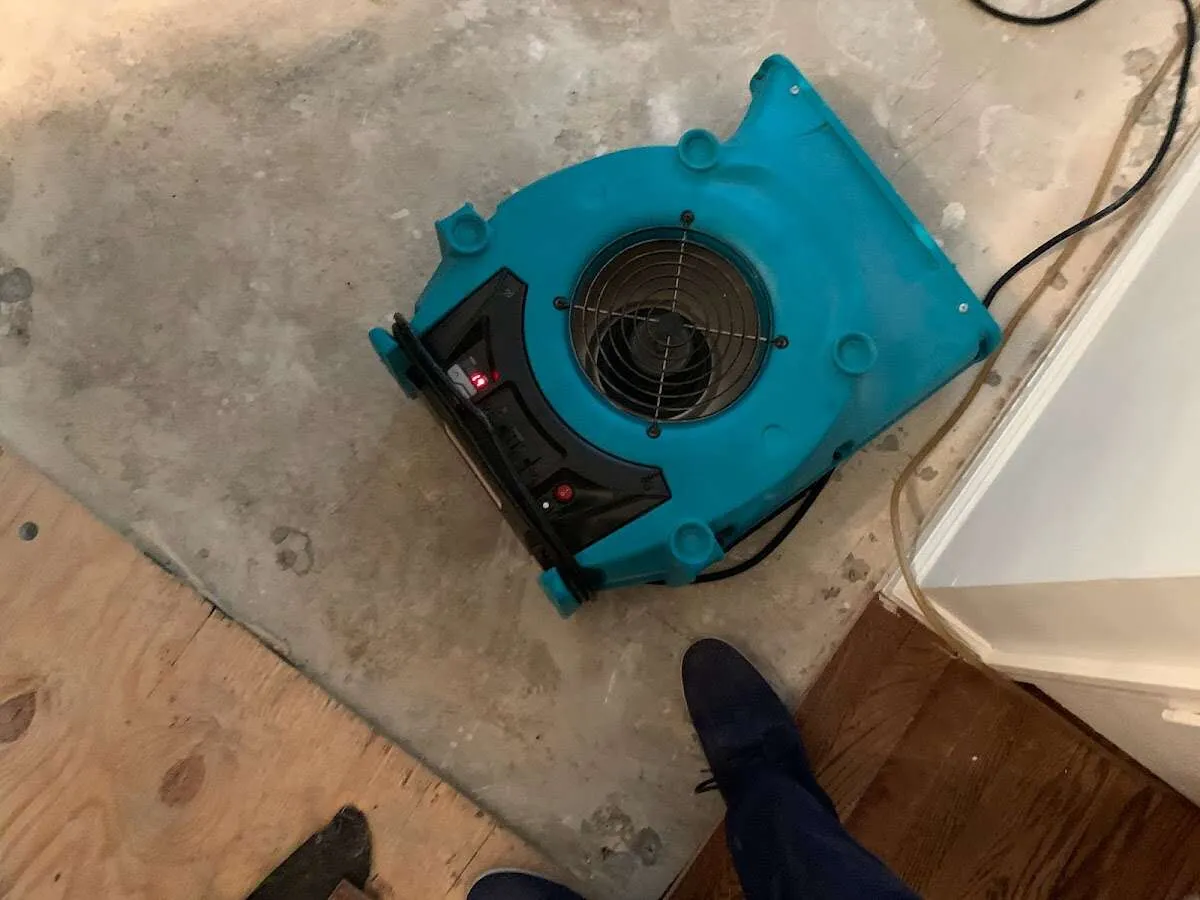 Air mover drying subfloor during Commercial Water Damage Restoration in Burke Centre